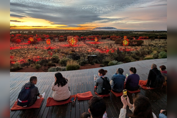 A group of tourists enjoying the view of Uluru