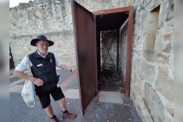 A tour guide opening a door