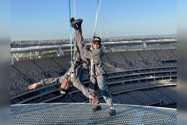 A man hanging upside down over a stadium